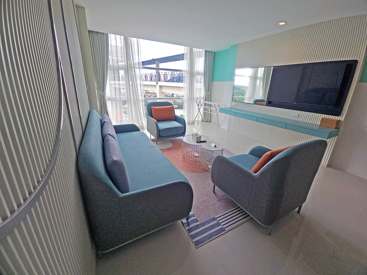A living room in a suite at Hilltop Wellness Resort in Phuket, Thailand, with armchairs, sofa, and TV; photo by Ivan Kralj.