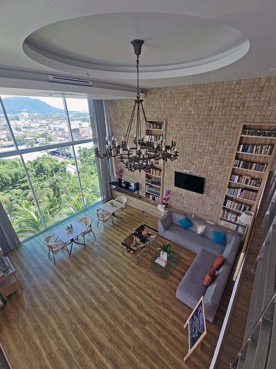 Plearn Lounge - a library and a co-working space at the Hilltop Wellness Resort, with floor-to-ceiling windows opening up to the panorama of Phuket City, Thailand; photo by Ivan Kralj.