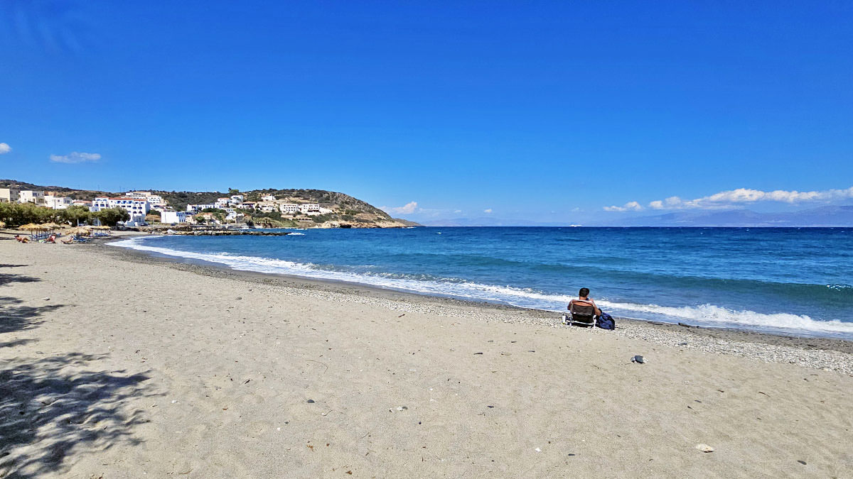 A lone man resting on the sandy beach in Agia Pelagia, on Kythira Island, Greece; photo by Ivan Kralj.