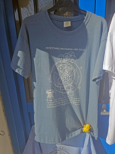 T-shirt with Antikythera Mechanism motif print, displayed outside a shop in Kythira, Greece; photo by Ivan Kralj.