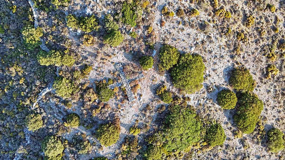 Aerial photo of a cross constructed of rocks on Apokleistra peninsula near Kapsali, on Kythira Island, Greece; drone photo by Ivan Kralj.