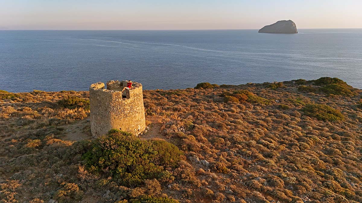 Aerial view of an abandoned windmill on Apokleistra peninsula during sunset, near Kapsali, on Kythira Island, Greece; drone photo by Ivan Kralj.