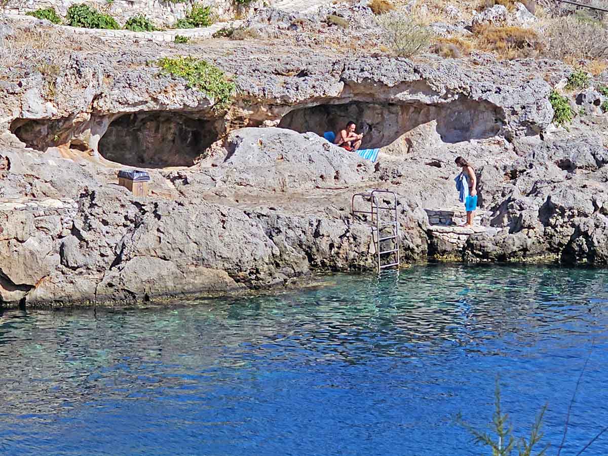 Swimmers resting in the caves of the Avlemonas beach in Kythira Island, Greece; photo by Ivan Kralj.