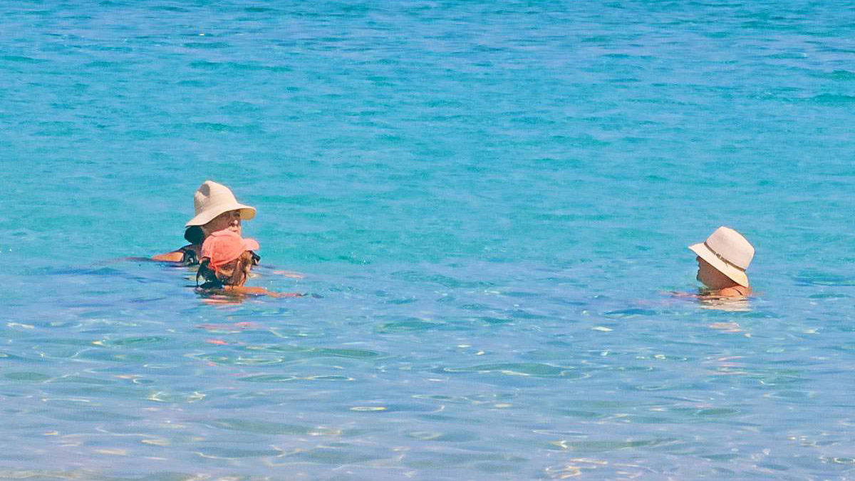 Female swimmers in hats resting in the turquoise waters of Diakofti Beach, Kythira Island, Greece; photo by Ivan Kralj.