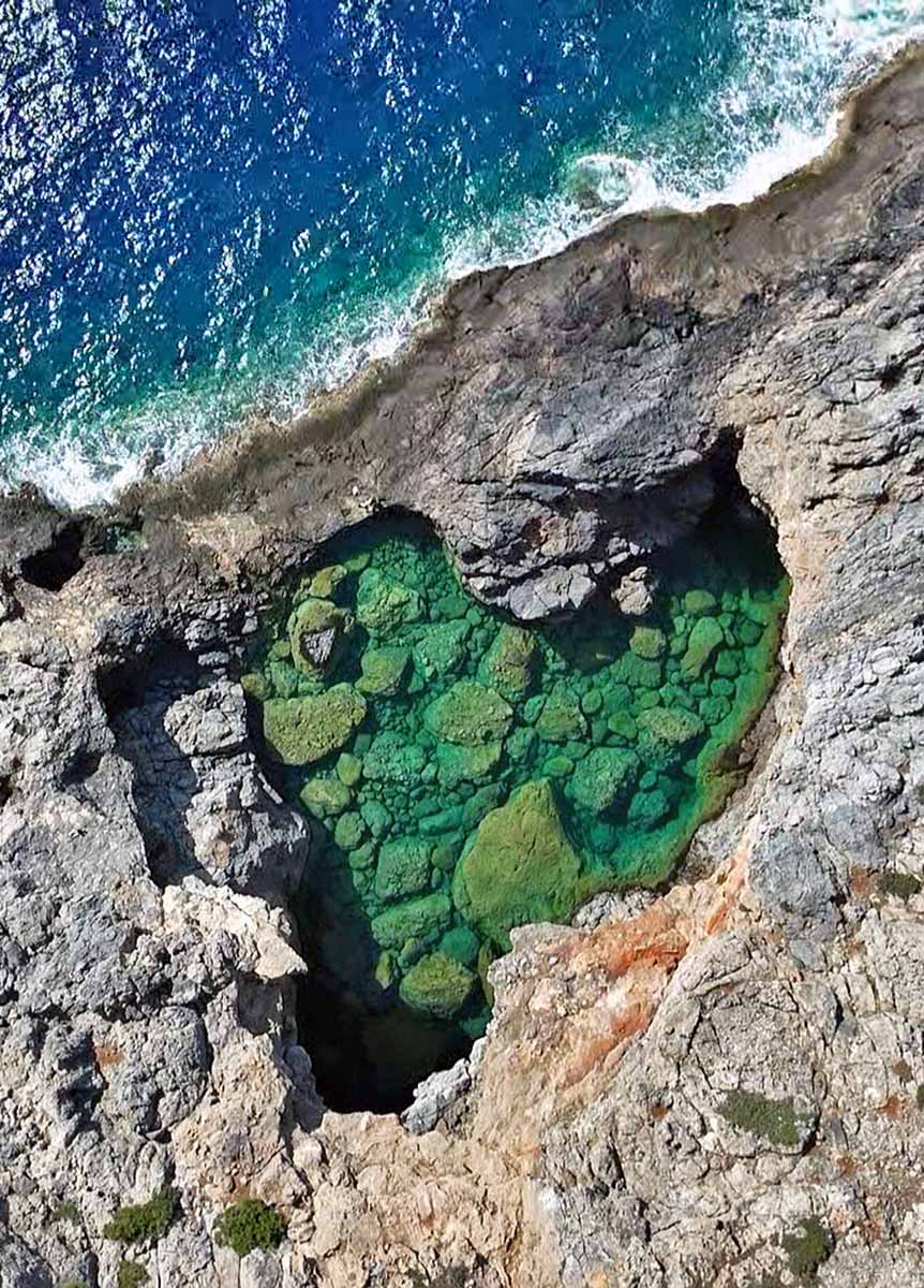 Aerial view of Prasini Limni, a heart-shaped Green Lake on Aphrodite's Kythira Island in Greece; drone photo by Ivan Kralj.