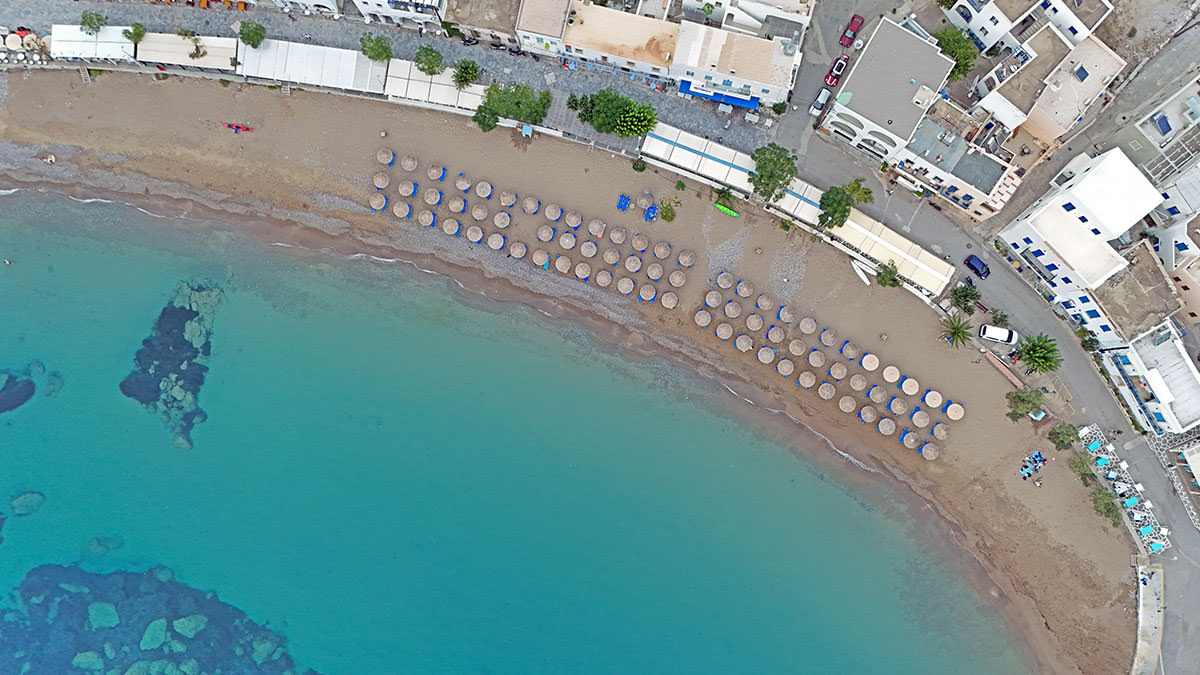 Aerial view of parasols on Kapsali Bay beach in Kythira, Greece; drone photo by Ivan Kralj.