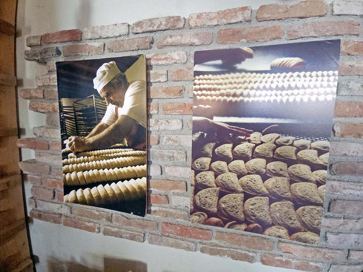 Photographs on the brick wall of Karavas Bakery in Karavas showing production of the famous Kythira rusks, on Kythira Island, Greece; photo by Ivan Kralj.