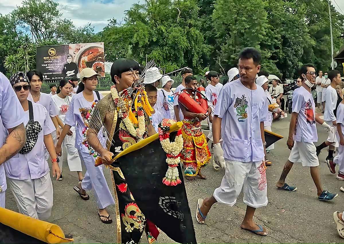 Kathu Shrine ma songs, one with spikes, other with fire extinguishers piercing their cheeks, walk in a procession during the Phuket Vegetarian Festival 2024, also known as the Nine Emperor Gods Festival; photo by Ivan Kralj.