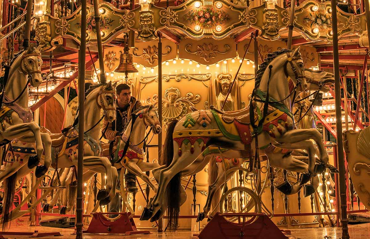 Glowing double-deck horse carousel Resslirytti at Petersplatz, one of the locations for Basler Herbstmesse, Basel Autumn fair; photo by Rolf Weber.