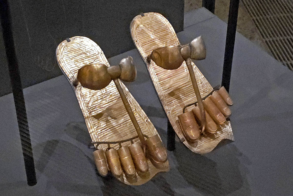 Sandals made of striped gold foil and golden straps were fitted on dead Tutanhkamun's wrapped feet with golden toes, to support his regeneration into an eternal god; displayed at Grand Egyptian Museum in Giza, photo by Ivan Kralj. 