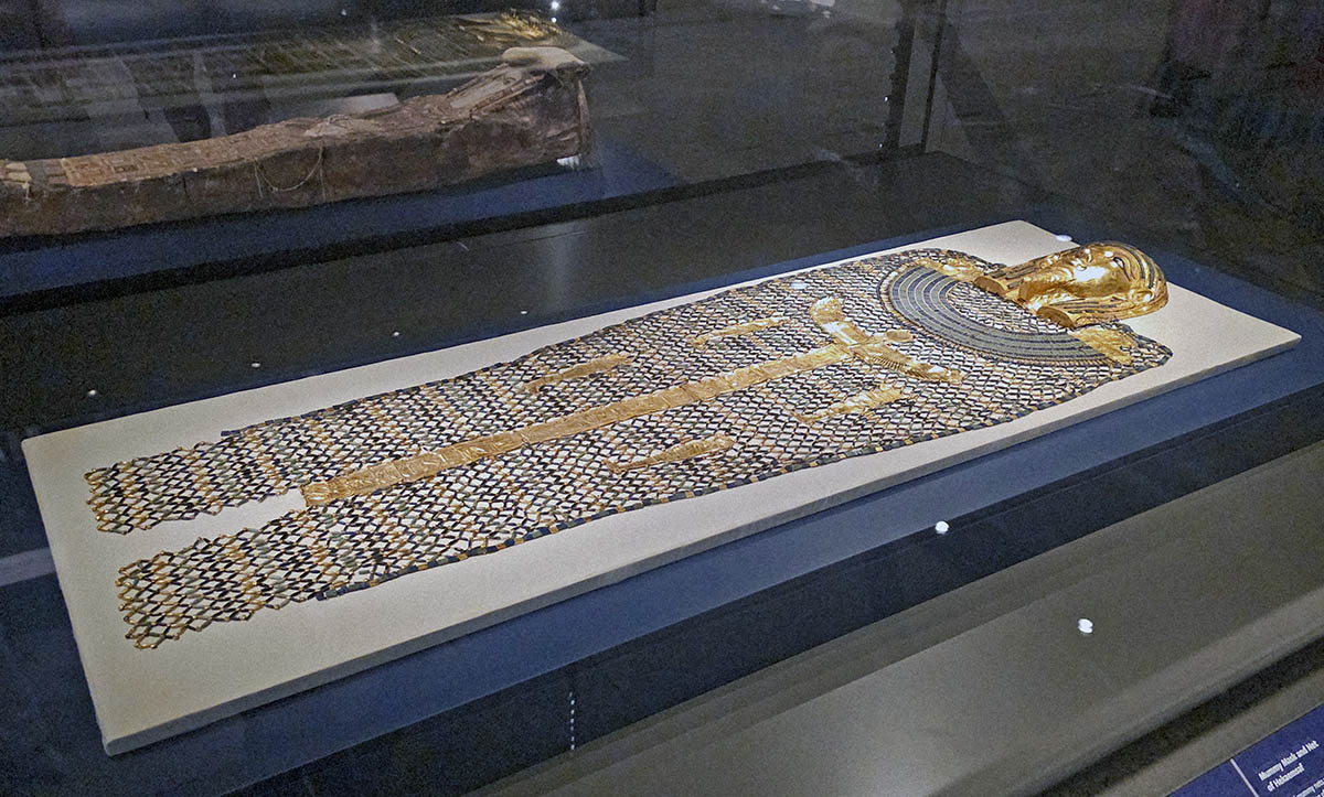 Golden mask and beaded mummy net of Hekaemsaf, a layer of magical protection for the dead body, enhanced with god figures; displayed at the Grand Egyptian Museum in Giza, Egypt, photo by Ivan Kralj.