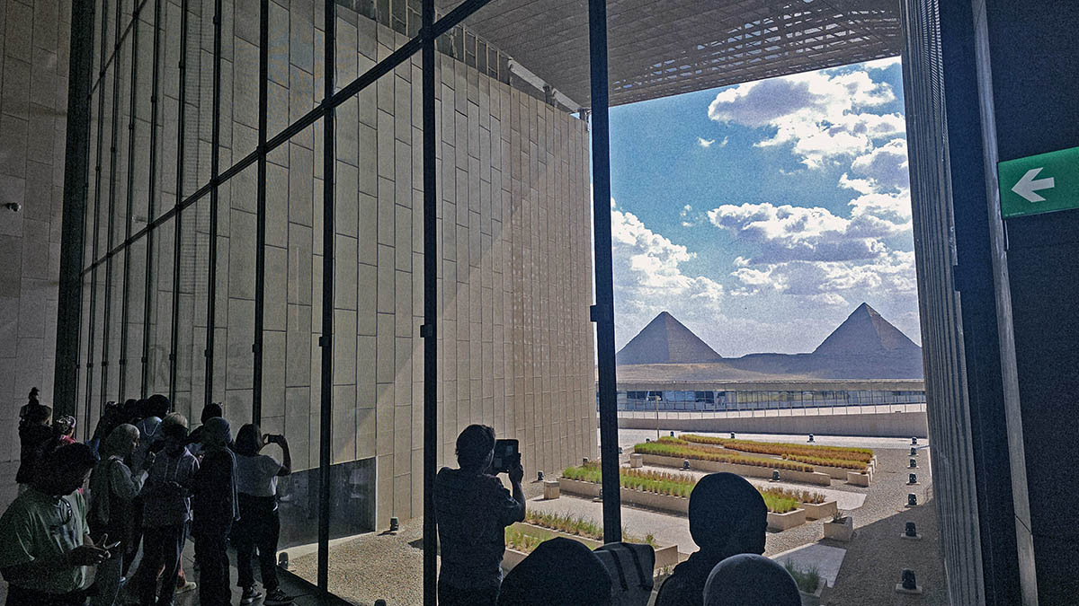 View of the Great Pyramids of Giza from the Grand Egyptian Museum, visitors taking pictures; photo by Ivan Kralj.