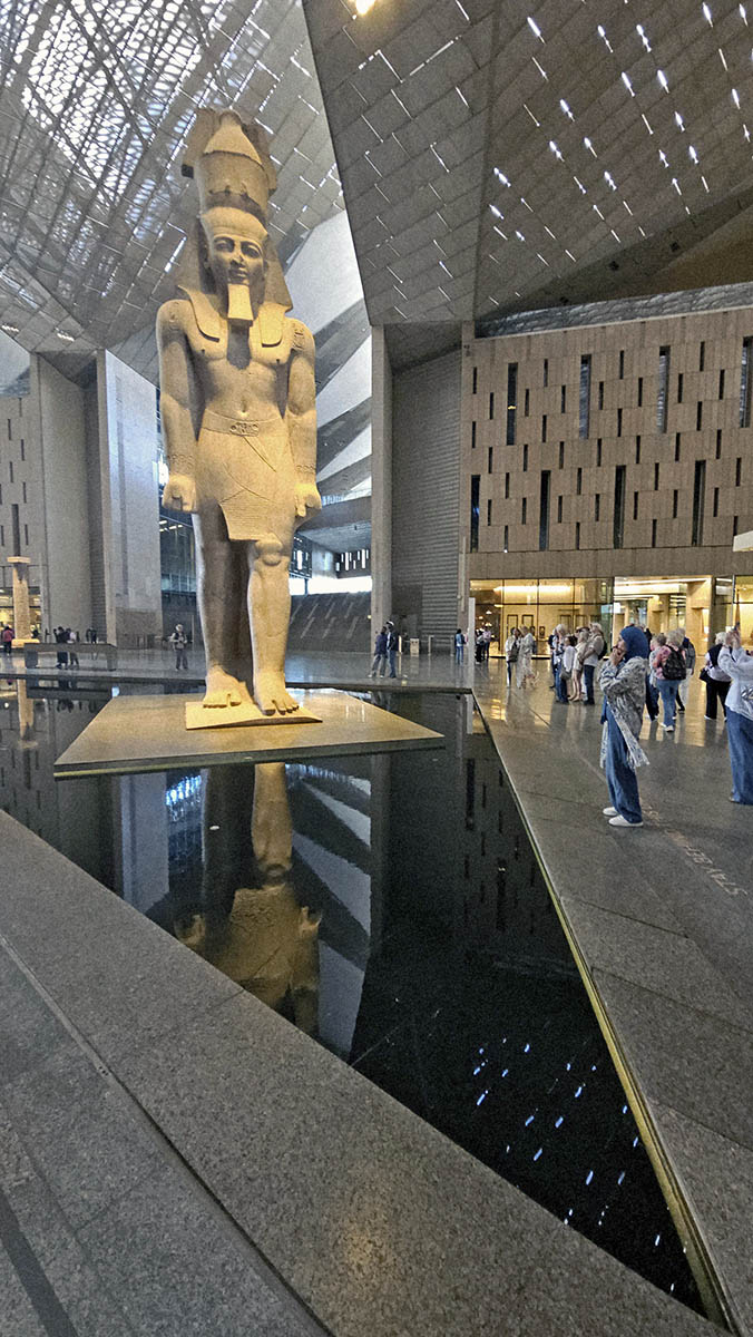 The colossal statue of Ramesses II in a triangular water feature at the Grand Egyptian Museum in Giza, Egypt; photo by Ivan Kralj.