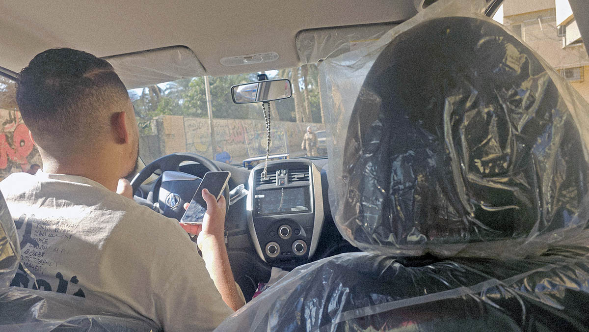 Uber car in Giza, Egypt, with everything wrapped in plastic protection - from seats and sun visors to driver's control stalks; photo by Ivan Kralj.