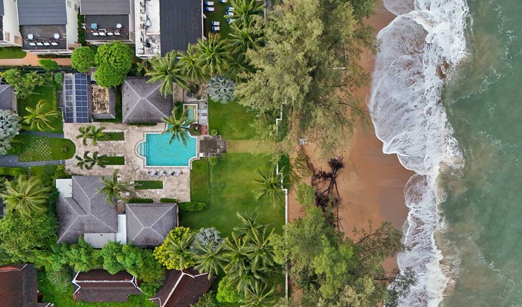 Aerial view of the Anda Mani Khao Lak Beachfront Villas in Phang Nga Province, Thailand, showing the resort's residences, greenery, and Lam Kaen Beach of Andaman Sea; drone photo by Ivan Kralj.