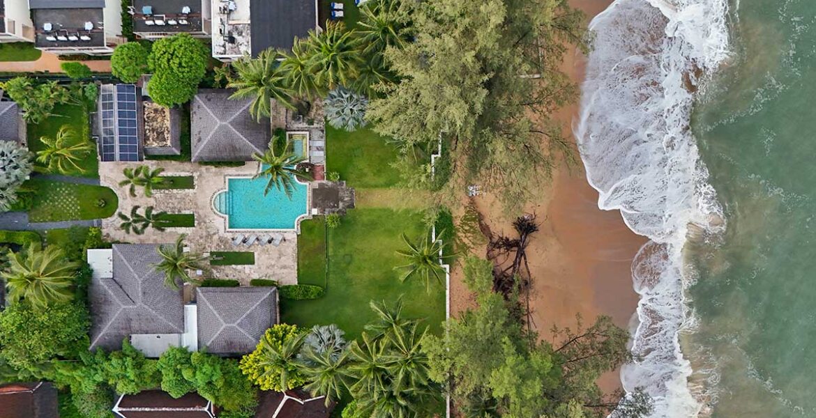 Aerial view of the Anda Mani Khao Lak Beachfront Villas in Phang Nga Province, Thailand, showing the resort's residences, greenery, and Lam Kaen Beach of Andaman Sea; drone photo by Ivan Kralj.