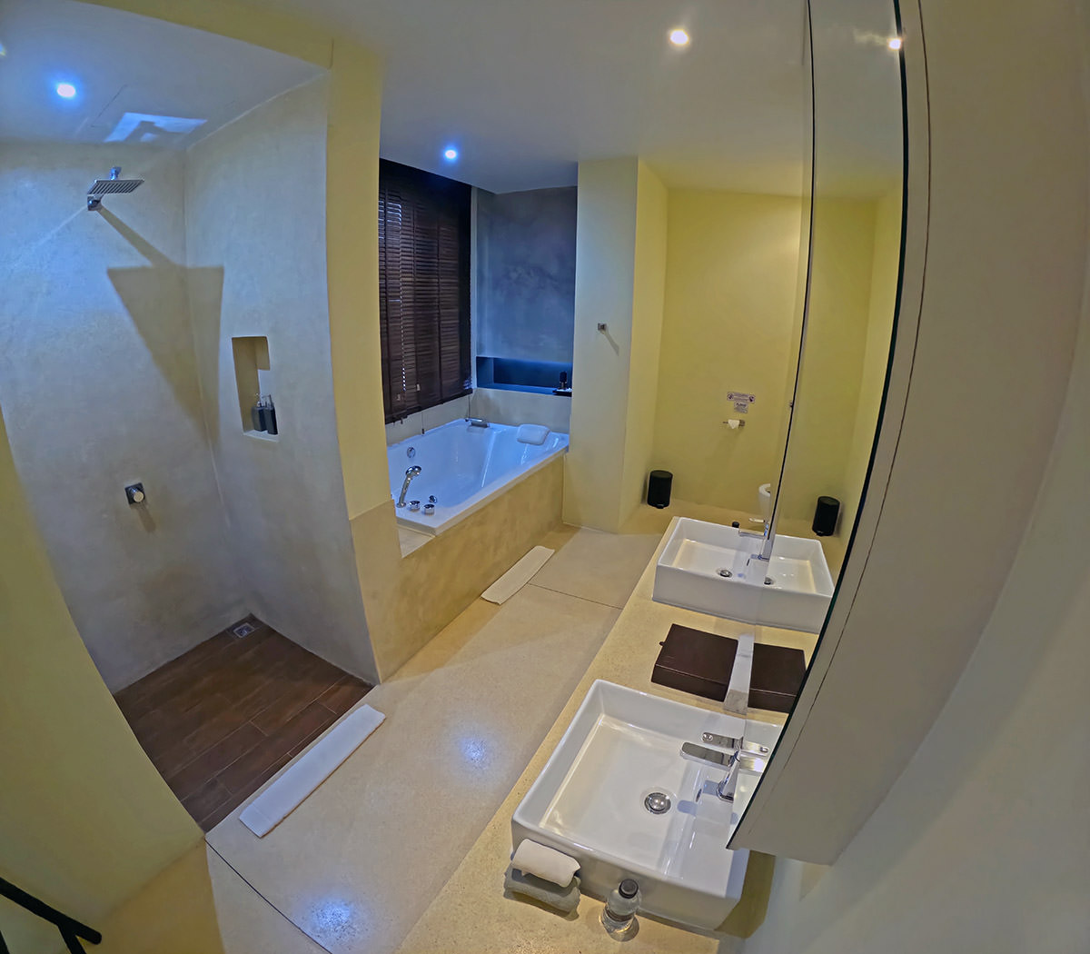 A bathroom in the Suite with Couple Bath at Anda Mani Khao Lak Beachfront Villas in Phang Nga, Thailand, with a walk-in rain shower, double-ended bathtub, and twin sinks; photo by Ivan Kralj.