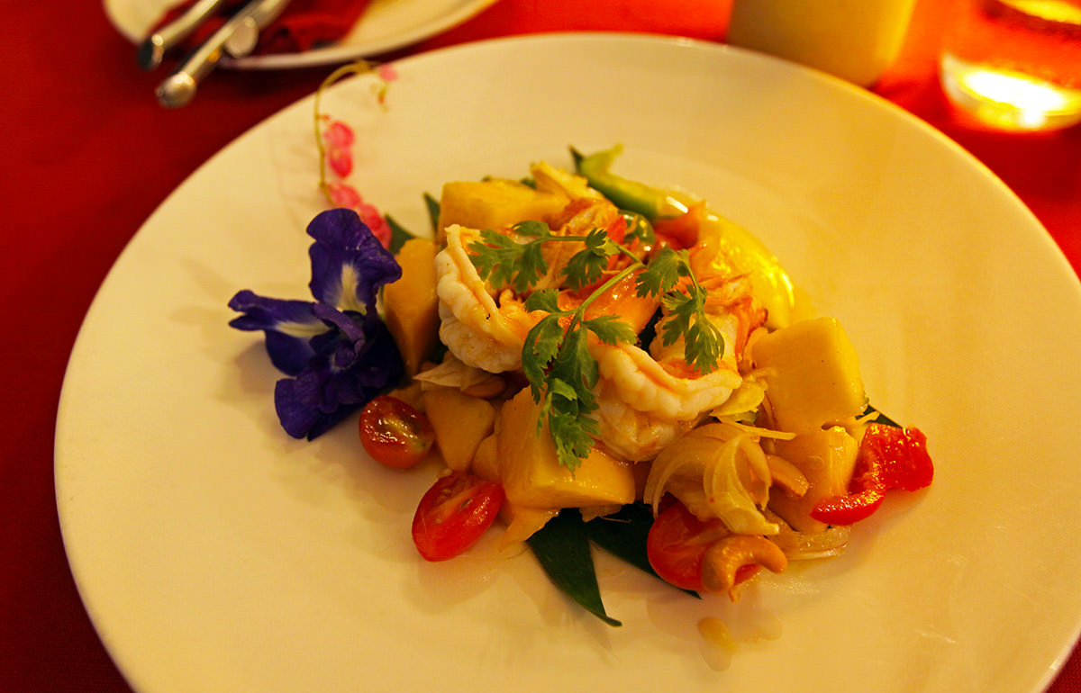 Mango-prawn salad with cashew nuts, tomatoes, and herbs, as served at The Kitchen, the on-site restaurant at Anda Mani Khao Lak Beachfront Villas in Thailand; photo by Ivan Kralj.