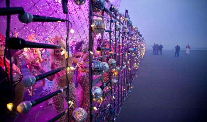 AI visualisation of the Eurovision Song Contest Live Tour party behind the glitter fence, after EBU's latest project deliberately concentrated its concerts only in Western Europe, leaving the rest of the continent behind the "iron curtain"; AI image by Ivan Kralj/ Reve, Adobe.