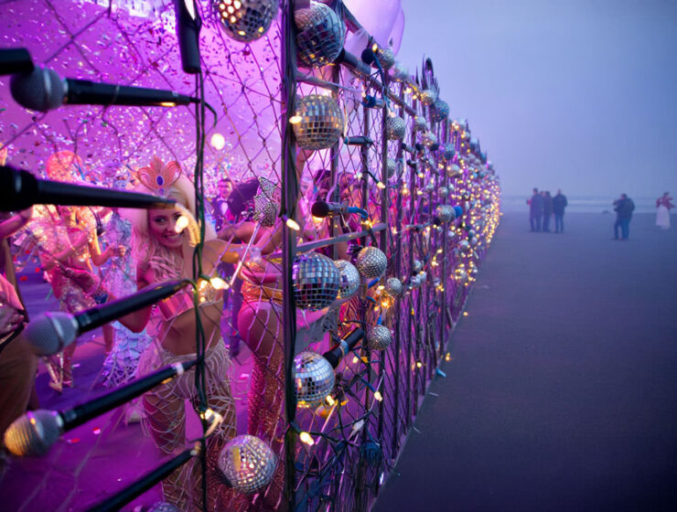 AI visualisation of the Eurovision Song Contest Live Tour party behind the glitter fence, after EBU's latest project deliberately concentrated its concerts only in Western Europe, leaving the rest of the continent behind the "iron curtain"; AI image by Ivan Kralj/ Reve, Adobe.