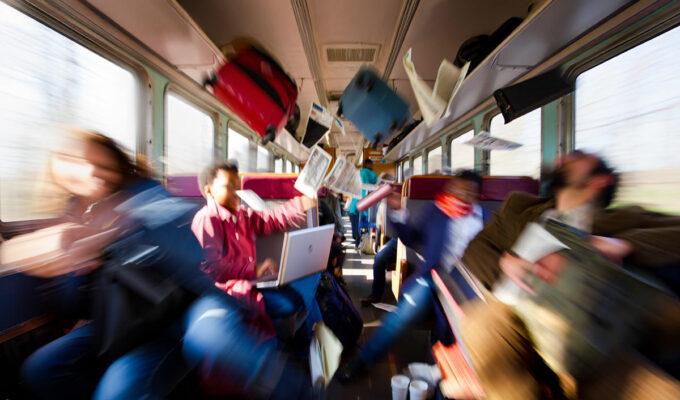 Train passengers in motion blur with flying objects during a train accident; an AI illustration for a practical guide on how to survive a train crash by Ivan Kralj / Reve, Adobe.