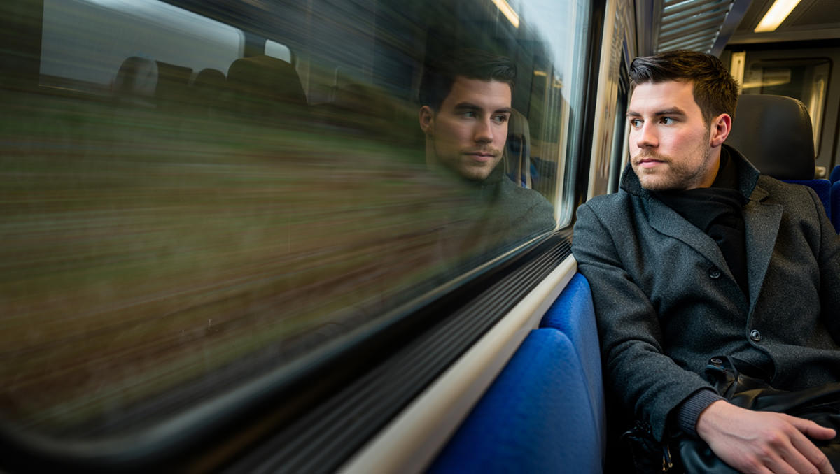 Train crash survival - passenger reflecting while looking through a train window; AI image by Ivan Kralj / Reve.