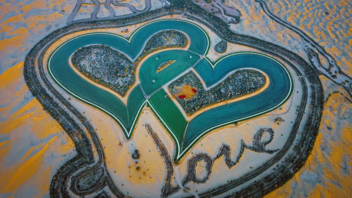 Love Lake, an artificial lake made of two interlocking hearts in Dubai, with trees spelling out the word "Love"; photo by Diego Ruso Pérez, Pexels.