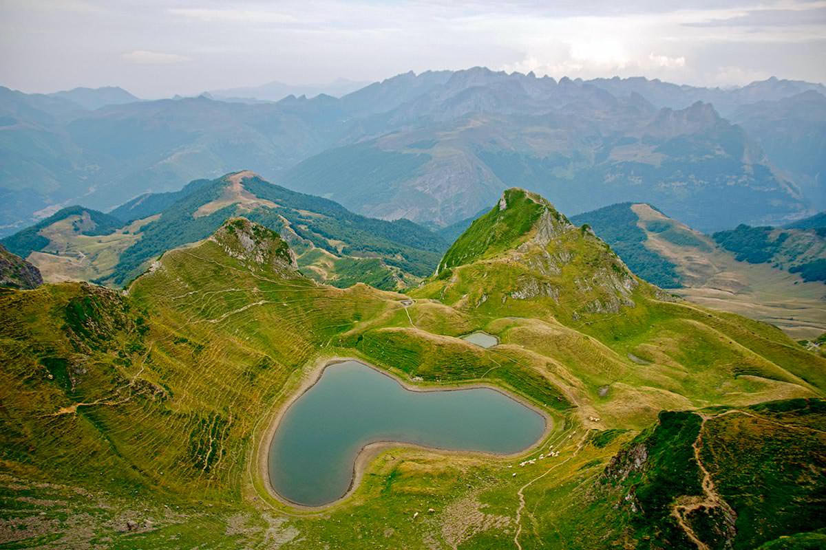 Aerial view of Lac du Montagnon, a heart-shaped lake in the French Pyrenees; photo by Jacint Bofill, Pexels.