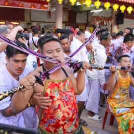 Ma song participants of the Phuket Vegetarian Festival, their cheeks pierced by sabers, awaiting the start of the procession from the Lim Hu Tai Su Shrine; photo by Ivan Kralj.
