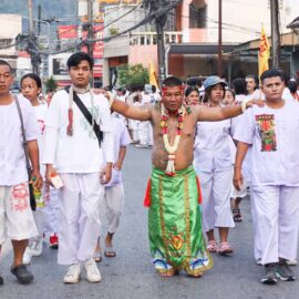 Ma song participant of the Phuket Vegetarian Festival, his body skin pierced with needles, walking in the procession from the Lim Hu Tai Su Shrine, Thailand; photo by Ivan Kralj.
