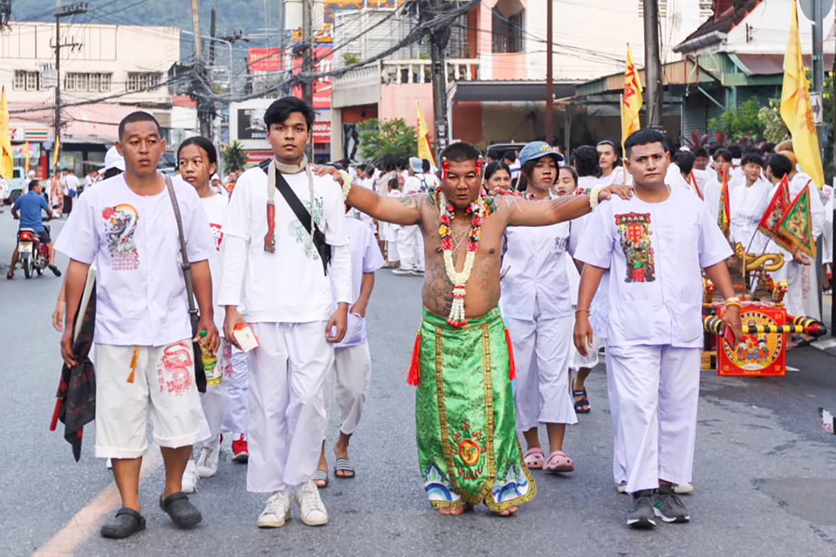 Ma song participant of the Phuket Vegetarian Festival, his body skin pierced with needles, walking in the procession from the Lim Hu Tai Su Shrine, Thailand; photo by Ivan Kralj.