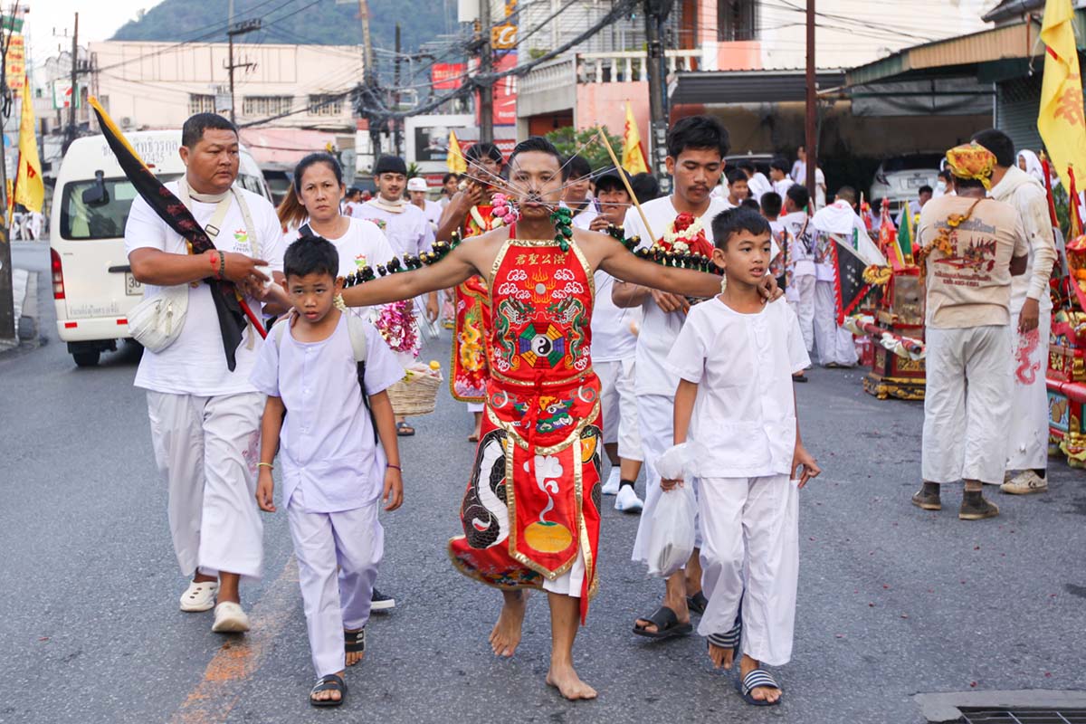 Ma song participant of the Phuket Vegetarian Festival, his face and arms pierced with spikes, walking in the procession from the Lim Hu Tai Su Shrine, Thailand; photo by Ivan Kralj.