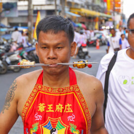 Ma song participant of the Phuket Vegetarian Festival, his face pierced with spikes, walking in the procession from the Lim Hu Tai Su Shrine, Thailand; photo by Ivan Kralj.
