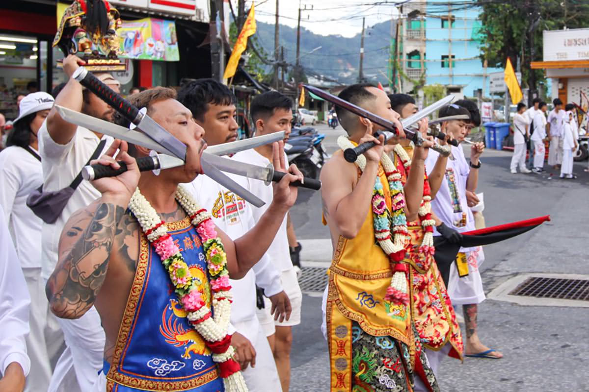 Ma song participants of the Phuket Vegetarian Festival, their faces pierced with swords, walking in the procession from the Lim Hu Tai Su Shrine, Thailand; photo by Ivan Kralj.
