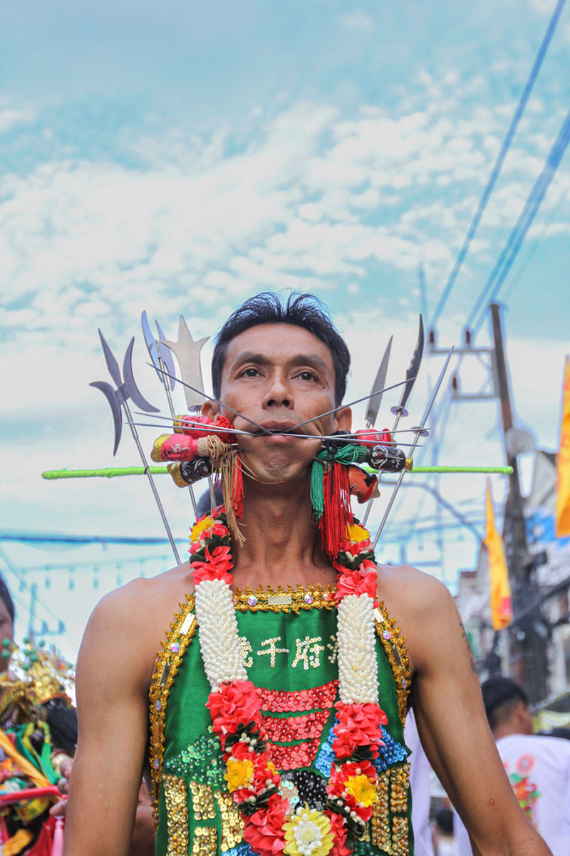 Ma song participant of the Phuket Vegetarian Festival, his face pierced with spikes, walking in the procession from the Lim Hu Tai Su Shrine, Thailand; photo by Ivan Kralj.