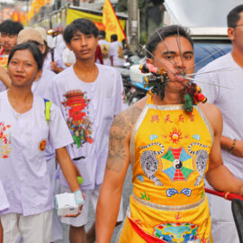Ma song participant of the Phuket Vegetarian Festival, his face pierced with spikes, walking in the procession from the Lim Hu Tai Su Shrine, Thailand; photo by Ivan Kralj.