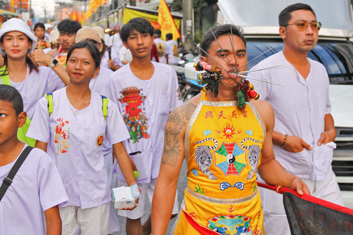 Ma song participant of the Phuket Vegetarian Festival, his face pierced with spikes, walking in the procession from the Lim Hu Tai Su Shrine, Thailand; photo by Ivan Kralj.