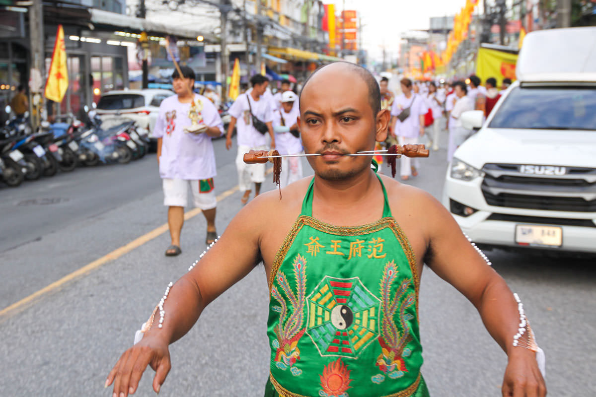 Ma song participant of the Phuket Vegetarian Festival, his face pierced with spikes, walking in the procession from the Lim Hu Tai Su Shrine, Thailand; photo by Ivan Kralj.