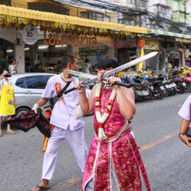 Ma song participant of the Phuket Vegetarian Festival, his face pierced with swords, walking in the procession from the Lim Hu Tai Su Shrine, Thailand; photo by Ivan Kralj.