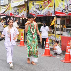 A young ma song participant of the Phuket Vegetarian Festival, his face pierced with a sword, walking in the procession from the Lim Hu Tai Su Shrine, Thailand; photo by Ivan Kralj.