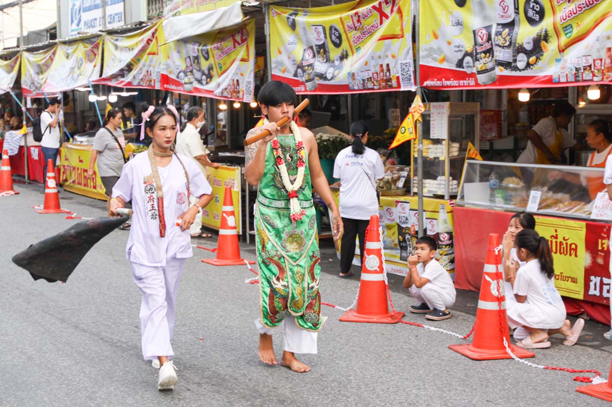 A young ma song participant of the Phuket Vegetarian Festival, his face pierced with a sword, walking in the procession from the Lim Hu Tai Su Shrine, Thailand; photo by Ivan Kralj.