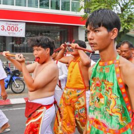 Ma song participants of the Phuket Vegetarian Festival, walking in the procession from the Lim Hu Tai Su Shrine while cutting their tongues with axes, Thailand; photo by Ivan Kralj.