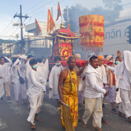 Participants of the Phuket Vegetarian Festival walking in the procession from the Lim Hu Tai Su Shrine, Thailand, while carrying a palanquin, a ceremonial sedan chair of the gods; photo by Ivan Kralj.