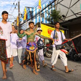 Ma song, a spirit medium at the Phuket Vegetarian Festival, his body wrapped in barbwire, walking in the procession from the Lim Hu Tai Su Shrine, Thailand; photo by Ivan Kralj.