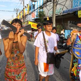 Ma song participants of the Phuket Vegetarian Festival, their faces pierced with rulers and knives, walking in the procession from the Lim Hu Tai Su Shrine, Thailand; photo by Ivan Kralj.