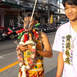 Ma song participant of the Phuket Vegetarian Festival, his face heavily pierced with spikes, walking in the procession from the Lim Hu Tai Su Shrine, Thailand; photo by Ivan Kralj.