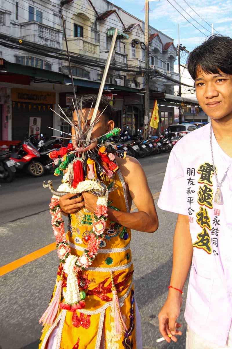 Ma song participant of the Phuket Vegetarian Festival, his face heavily pierced with spikes, walking in the procession from the Lim Hu Tai Su Shrine, Thailand; photo by Ivan Kralj.