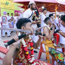 Ma song participants of the Phuket Vegetarian Festival, their cheeks pierced by swords, sitting at the Lim Hu Tai Su Shrine, awaiting the start of the procession; photo by Ivan Kralj.
