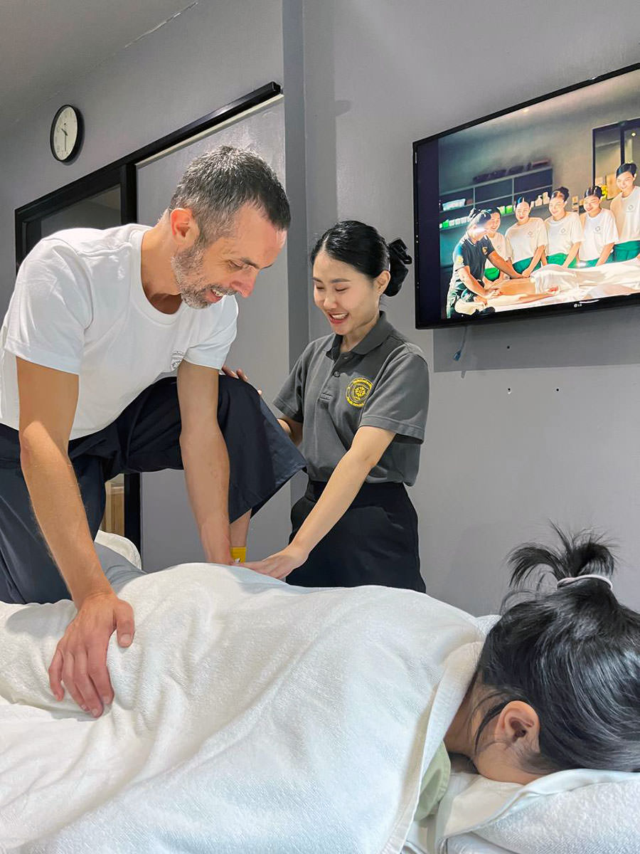 Ivan Kralj in hand-on learning of the Thai massage course at Oasis Spa School in Chiang Mai, Thailand.