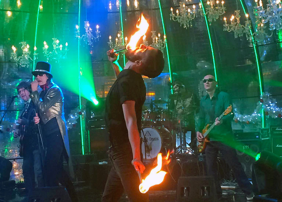 Croatian singer Davor Gobac with his rock band Psihomodo Pop performing his song "Donna" for Croatian TV's New Year's Eve show in the company of a fire eater Ivan Kralj; photo by Elodie Peltier.